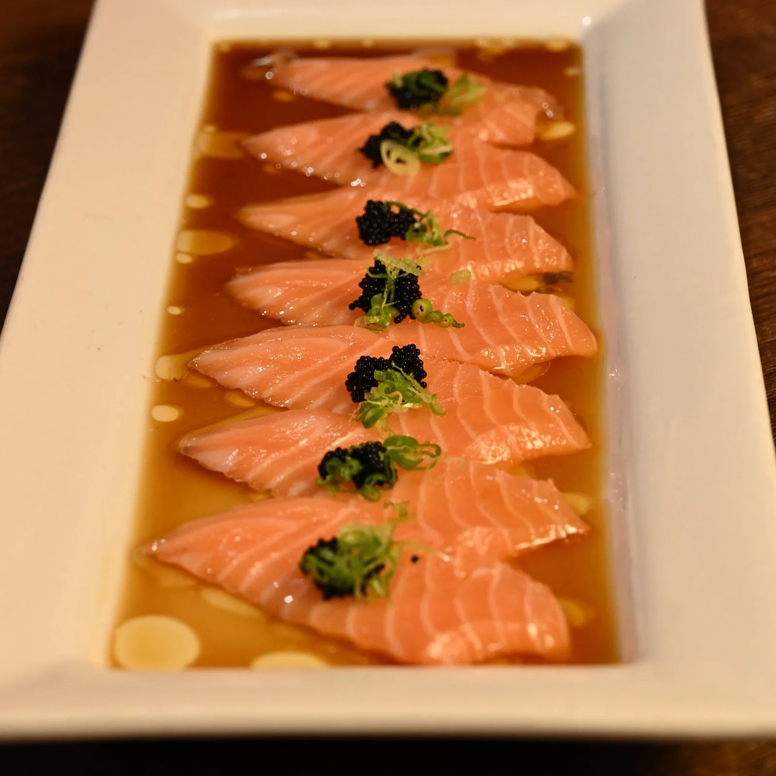 Salmon sashimi in ponzu with caviar — the water side